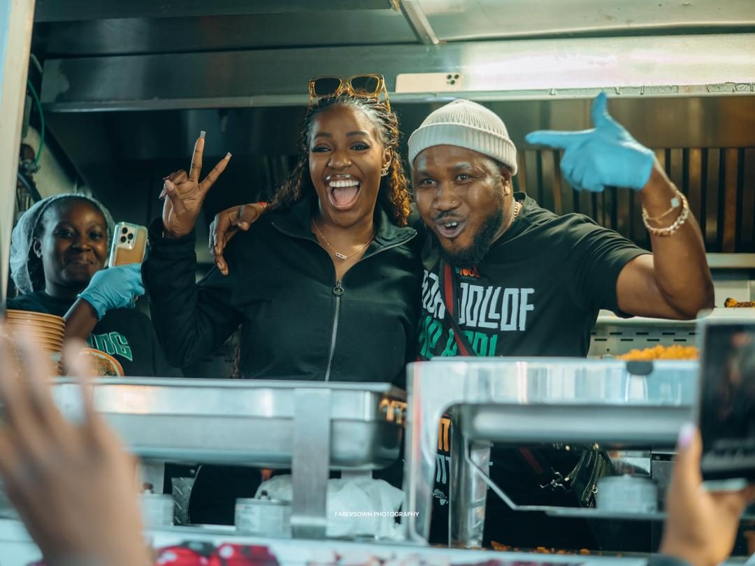 Food truck team serving jollof to smiling guests