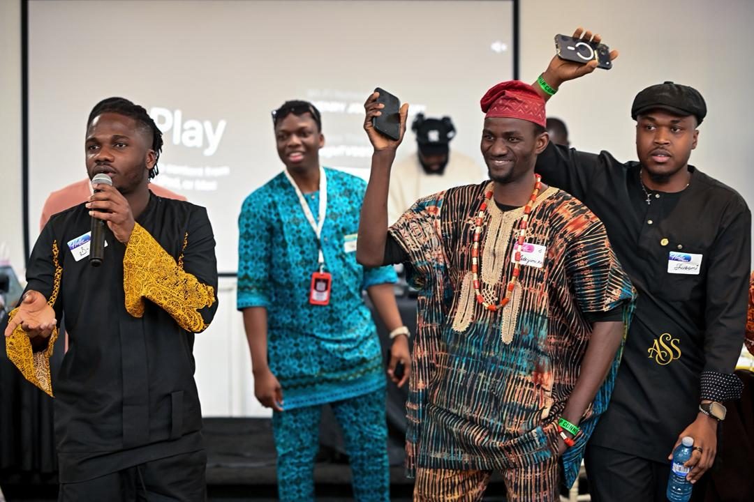 Hosts and guests on the mic in traditional attire during an event segment
