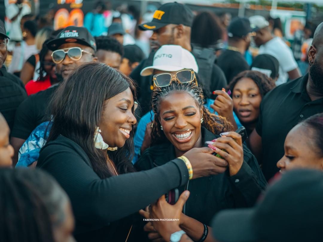 Friends laughing together at an outdoor food festival