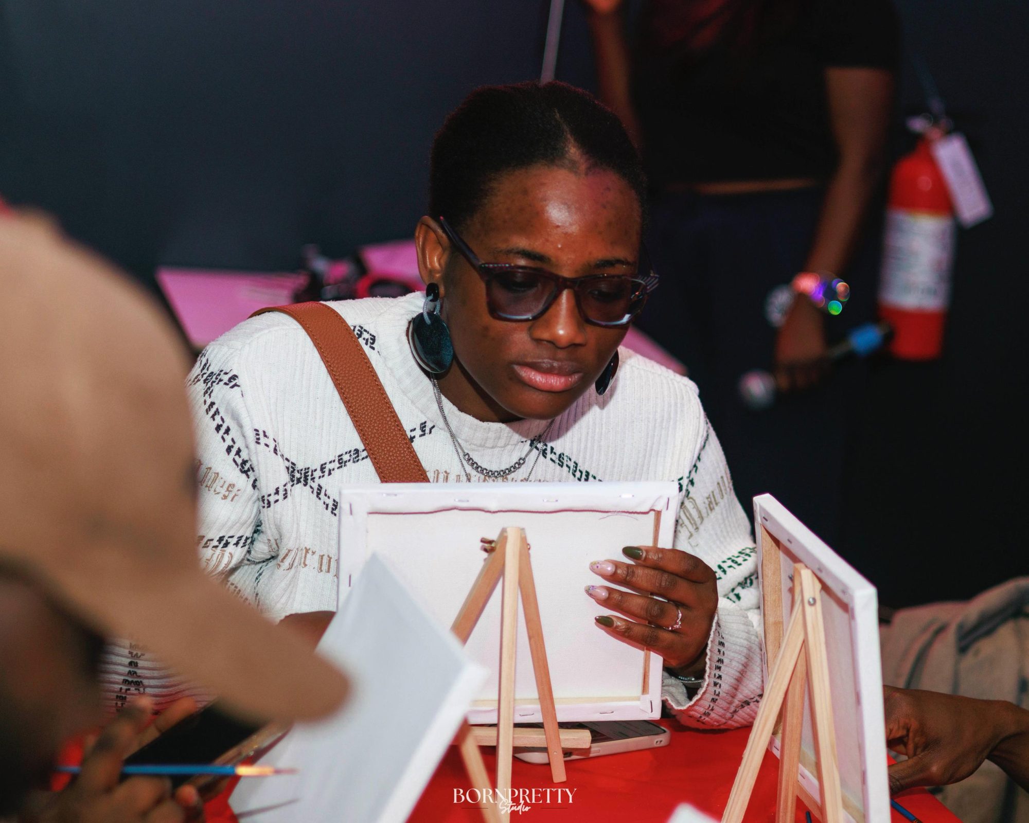 Guest painting on a mini canvas at a paint and sip night
