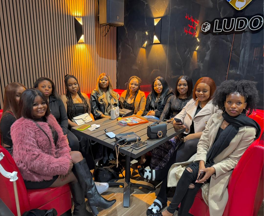 Group of friends seated together at a Ludo lounge night