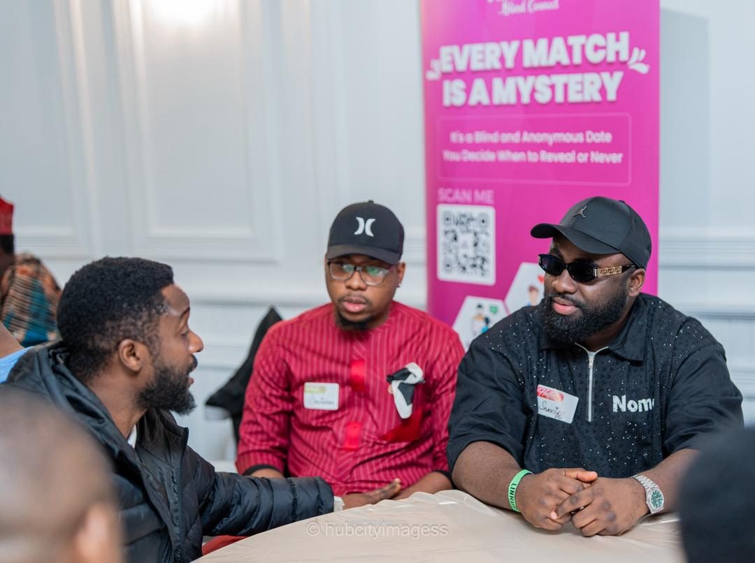 Guests in conversation beside a blind-date event banner