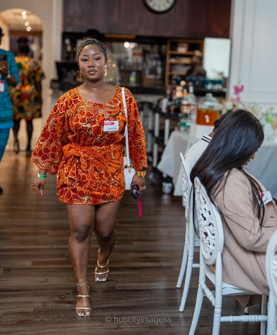 Guest walking through the venue in orange lace attire