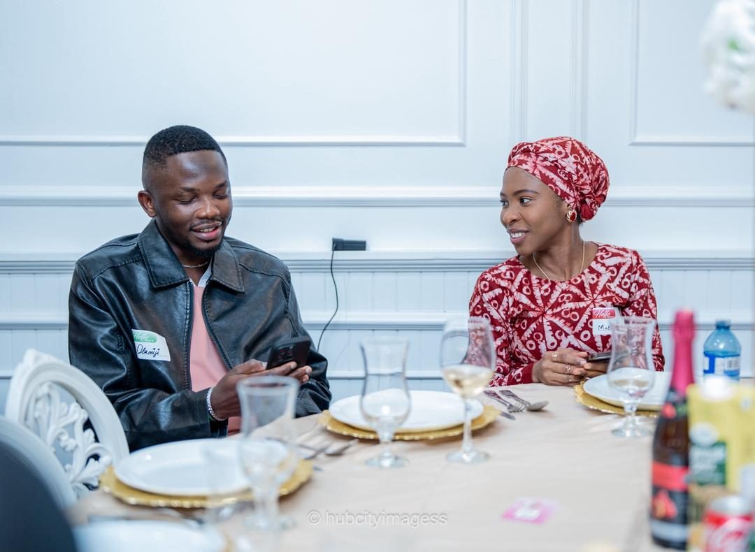 Two guests chatting over a set dinner table at a linkup