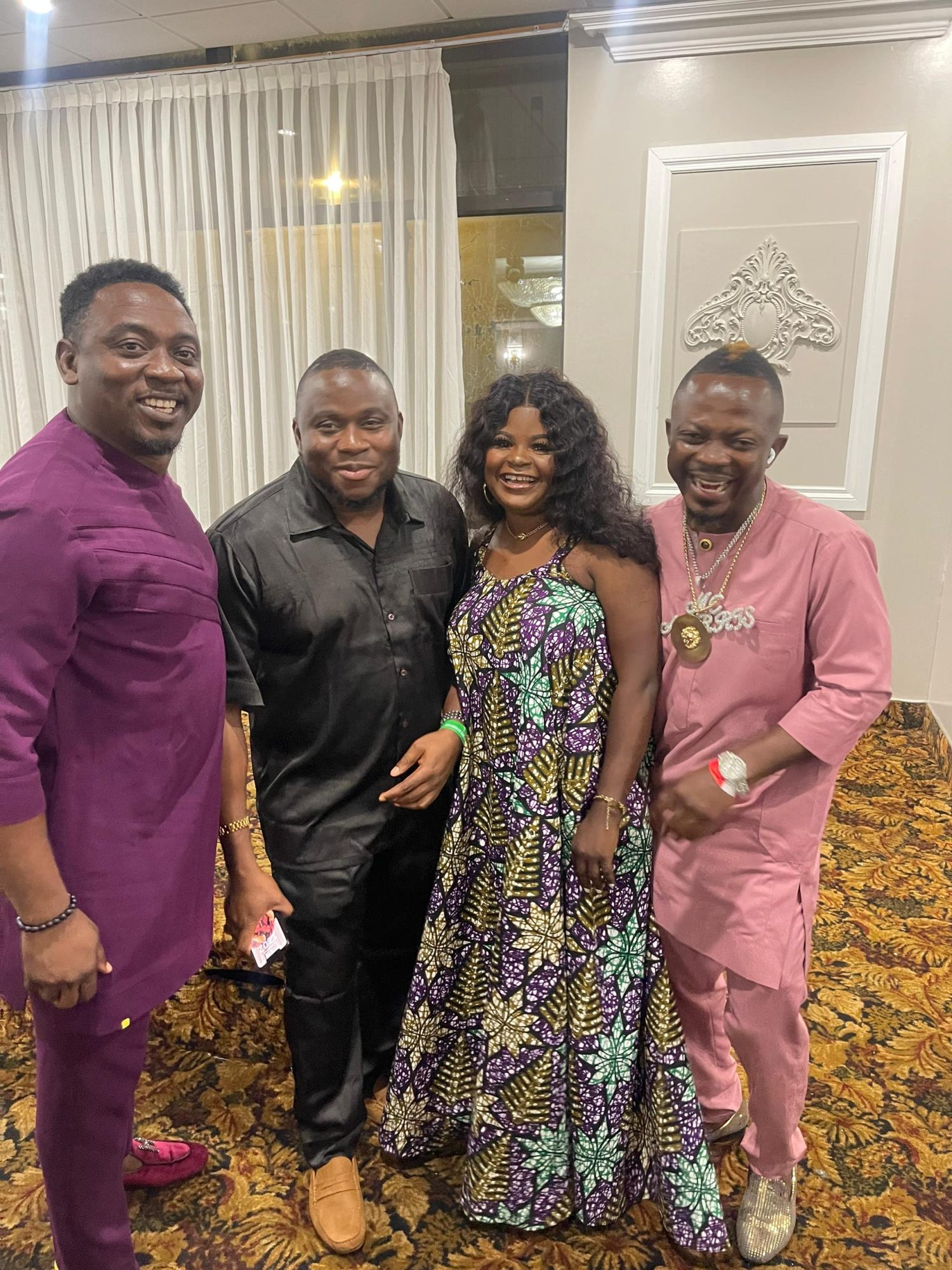 Friends posing together in African print at a gala