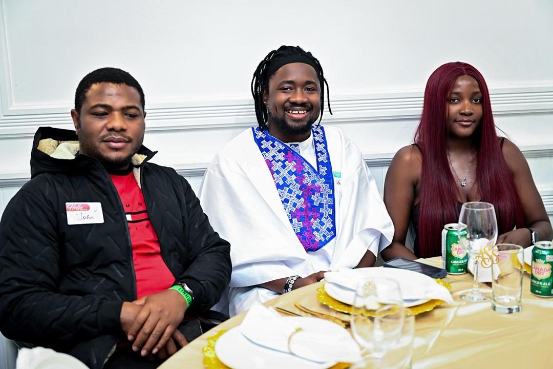 Three guests seated together at a decorated dinner table